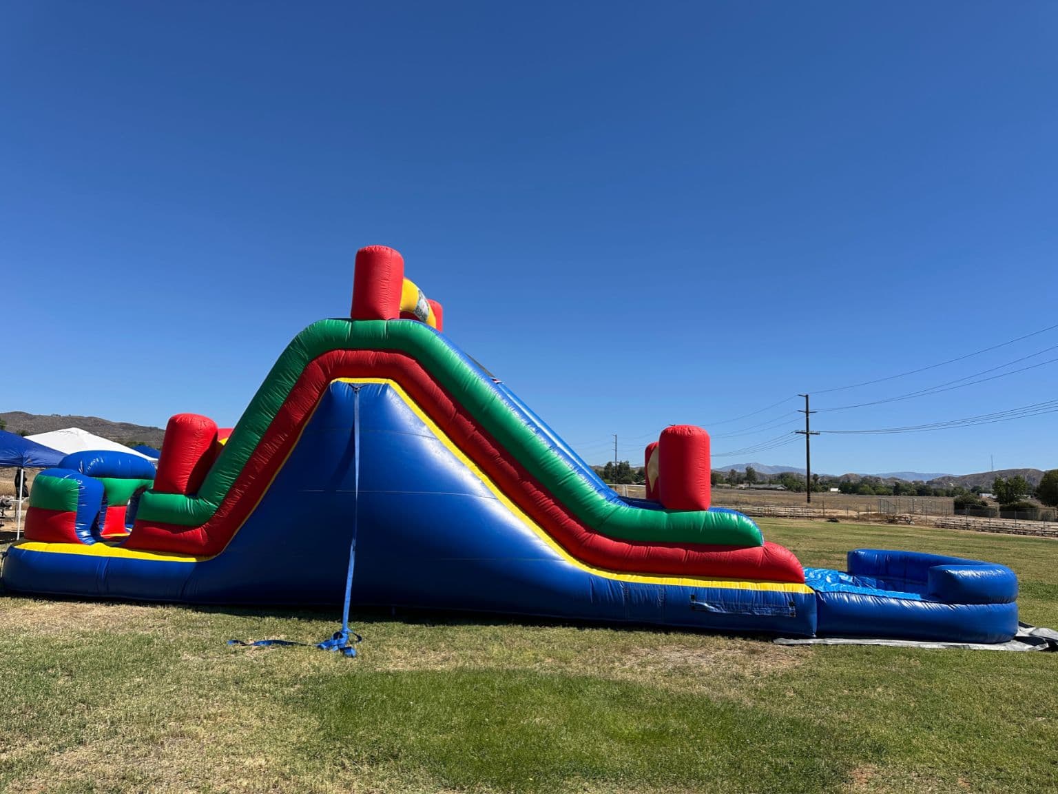 Kids laughing and playing together outdoors at a party